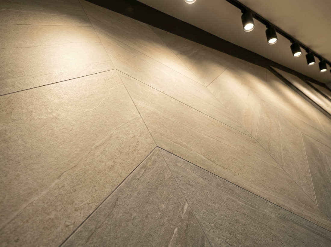 Floor tile samples including vitrified and stone-look finishes